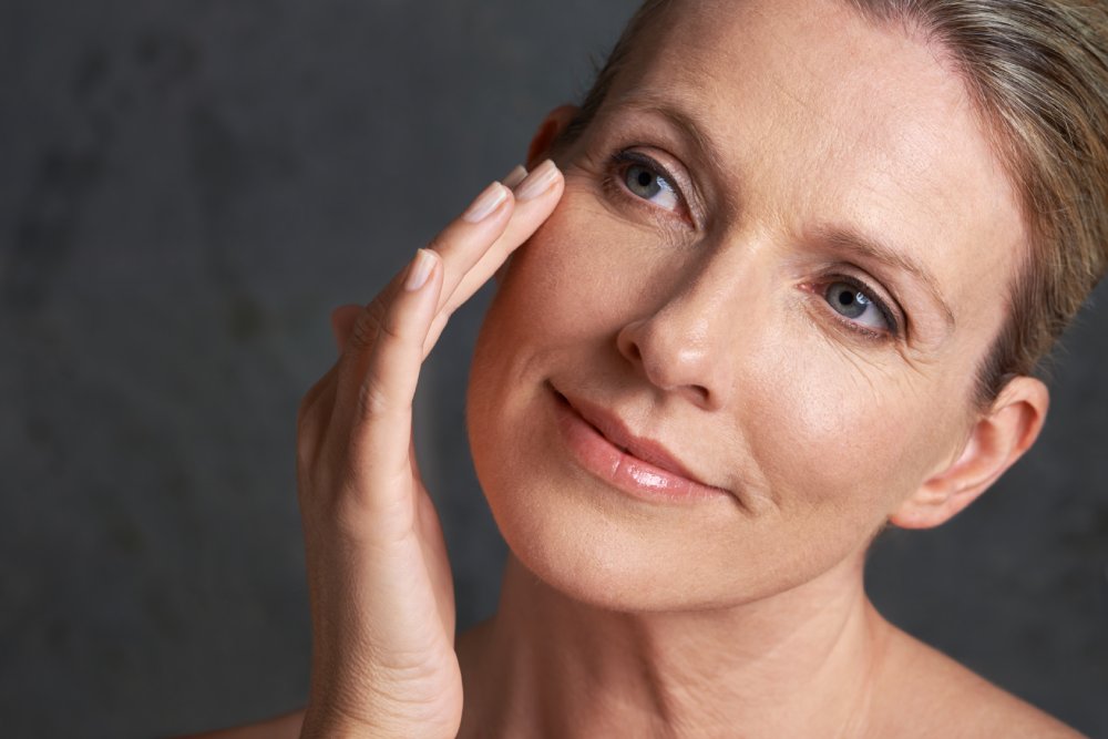 Mature woman touching her face